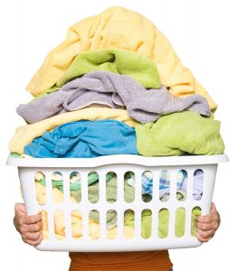 Man holding basket piled high with washing